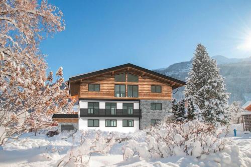 a home in the winter with snow on the ground at Apartment in Bramberg am Wildkogel with barbecue in Bramberg am Wildkogel