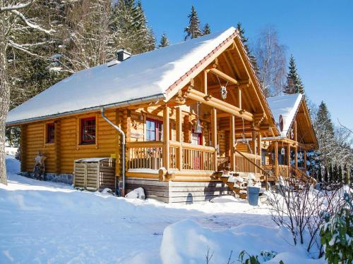 a large wooden cabin in the snow with snow at Blockhaus mit Sauna und Kamin in Schierke in Schierke