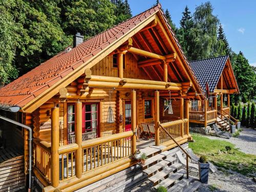 a log cabin with a red roof at Blockhaus mit Sauna und Kamin in Schierke in Schierke
