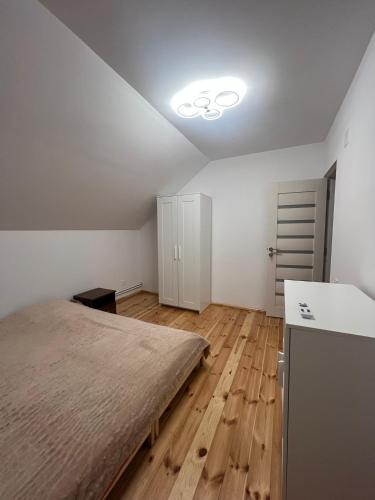 a bedroom with a bed and a white ceiling at Casa Lupu in Platoneşti