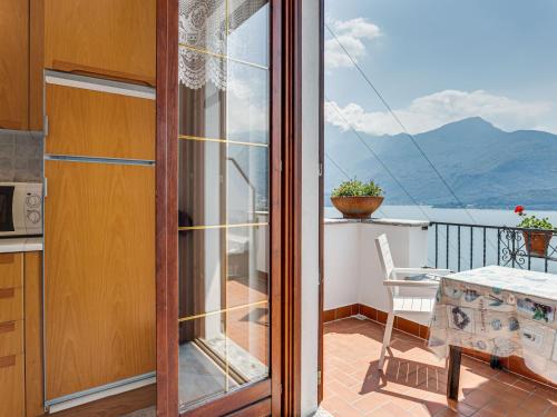 a balcony with a view of the mountains at Wonderful flat with swimming pool, lift and garden in Gravedona