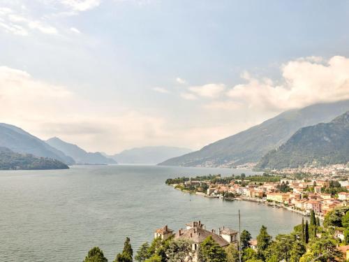 a town on the shore of a lake with mountains at Wonderful flat with swimming pool, lift and garden in Gravedona