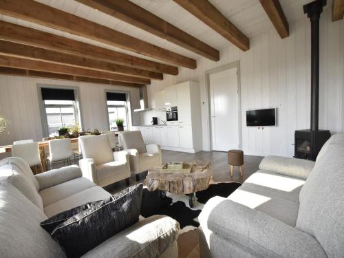 a living room with couches and a table at Studio Hazenborgh in Callantsoog near the sea in Callantsoog
