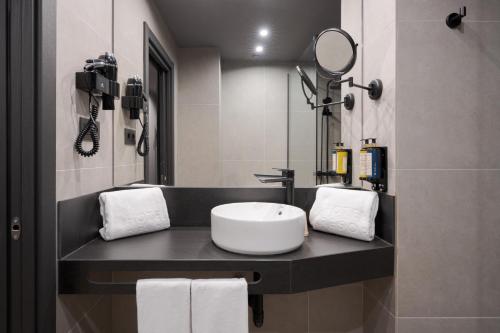 a bathroom with a sink and a mirror at Hotel LIVVO La Escarlata in Las Palmas de Gran Canaria