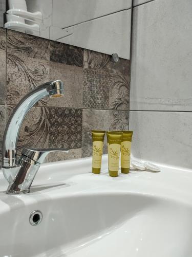 two yellow cups sitting on top of a sink at VILLA IATROU in Potos