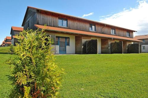 a house with a green lawn in front of it at Harz Holiday Park, Hasselfelde in Hasselfelde