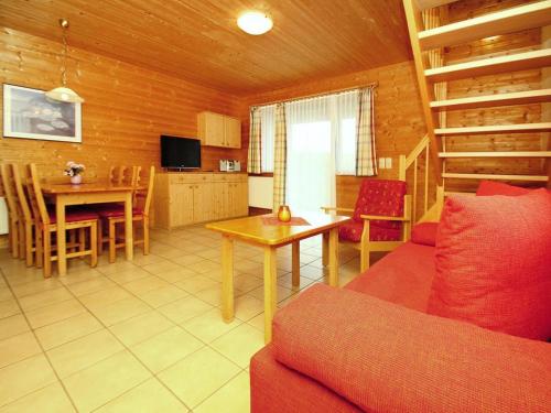 a living room with a couch and a table at Harz Holiday Park, Hasselfelde in Hasselfelde