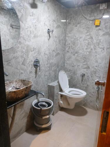 ein Badezimmer mit Toilette und Waschbecken in der Unterkunft Hotel Lotus Lide in Gandhinagar