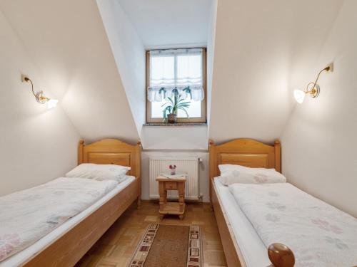 two beds in a small room with a window at Spacious Apartment with Sauna in Schonsee in Dietersdorf