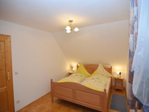 a bedroom with a bed with yellow pillows on it at Spacious Apartment with Sauna in Schonsee in Dietersdorf