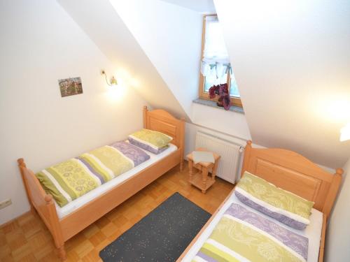 a small bedroom with two beds and a mirror at Spacious Apartment with Sauna in Schonsee in Dietersdorf