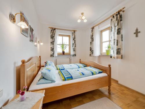 a bedroom with a bed with blue pillows at Spacious Apartment with Sauna in Schonsee in Dietersdorf