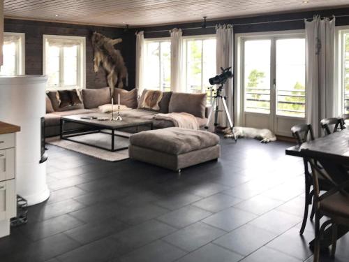 a living room with a couch and a table at 15 person holiday home in Treungen in Treungen