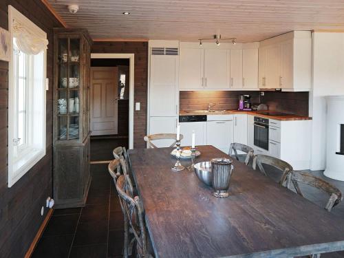 a kitchen with a wooden table and chairs at 15 person holiday home in Treungen in Treungen