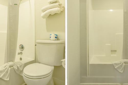 a white bathroom with a toilet and a shower at Townhouse Barstow On Historic Route 66 CA I 15 in Barstow