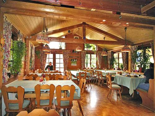 a restaurant with tables and chairs in a room at Holiday homes Lauterdörfle, Hayingen in Hayingen