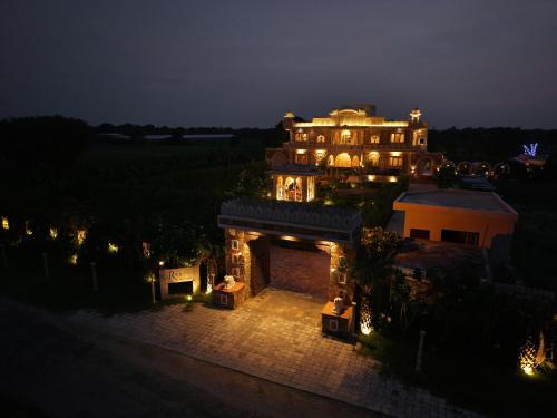 an aerial view of a large mansion at night at SaffronStays Raj Reverie in Jaipur