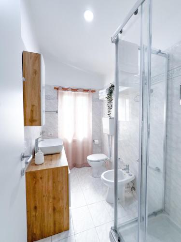 a bathroom with a shower and a toilet and a sink at Casa Romeo - Sea View Apartment in Focene