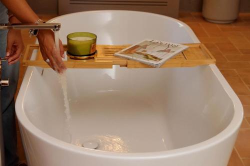 a bath tub with water being poured into it at The Monteleone Umbria Retreat in Monteleone dʼOrvieto