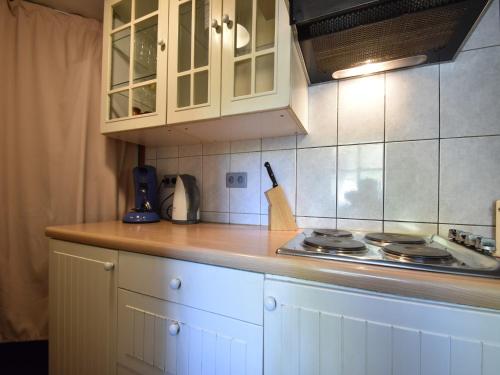 a kitchen with a stove and a counter top at Cottage with Bubble Bath in Modave
