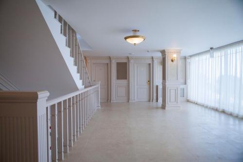 an empty hallway with a staircase in a house at Hotel Sulina International in Mamaia