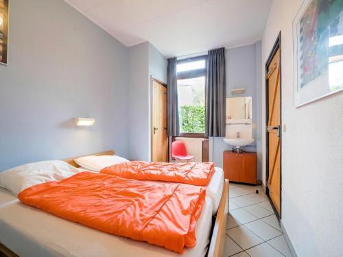 a hotel room with two beds and a window at Serene Holiday Home in Ulestraten with Terrace in Ulestraten