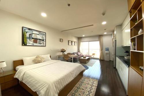 a bedroom with a bed and a living room at Lancaster Hanoi City Center Apartments in Hanoi