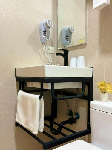 a bathroom with a sink and a mirror at Wemeet Hotel Taipei in Taipei
