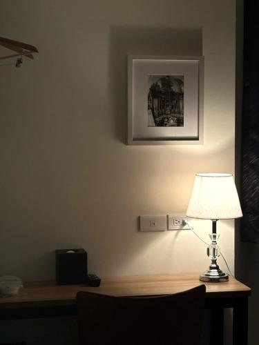 a lamp sitting on a desk in a room at Wemeet Hotel Taipei in Taipei