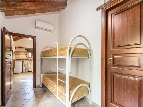 a room with two bunk beds and a door at Ancient holiday home in the countryside of Stilo with garden in Guardavalle