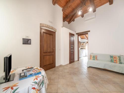 a living room with a tv and a couch at Ancient holiday home in the countryside of Stilo with garden in Guardavalle