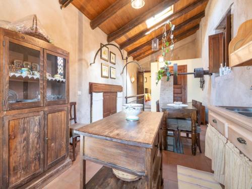 a kitchen with a wooden island in a room at Ancient holiday home in the countryside of Stilo with garden in Guardavalle