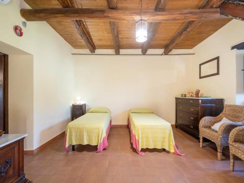 a room with two beds and a dresser in it at Ancient holiday home in the countryside of Stilo with garden in Guardavalle