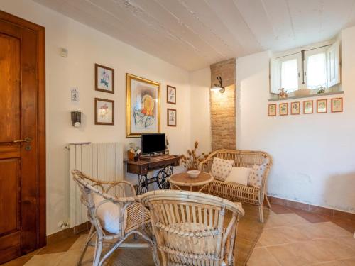 a living room with wicker chairs and a table at Ancient holiday home in the countryside of Stilo with garden in Guardavalle