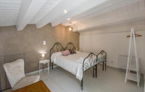 a bedroom with a bed and a cross on the wall at Amazing Home In Palazzolo Acreide With Wifi in Palazzolo Acreide