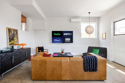 a living room with a couch and a table at A Min Walk to 6th St I 1 BR Home in East ATX in Austin