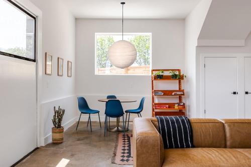 a living room with a couch and a table at A Min Walk to 6th St I 1 BR Home in East ATX in Austin