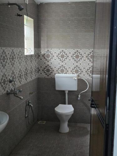 a bathroom with a toilet and a sink at Golden Pearl Beach Resort in Baga