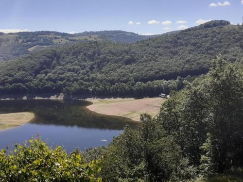 a view of a lake in the hills at Peaceful Mountain Retreat in Neuvéglise