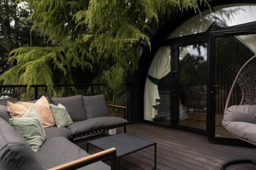 a living room with a couch on a wooden deck at AvantGlamp in Marston Green