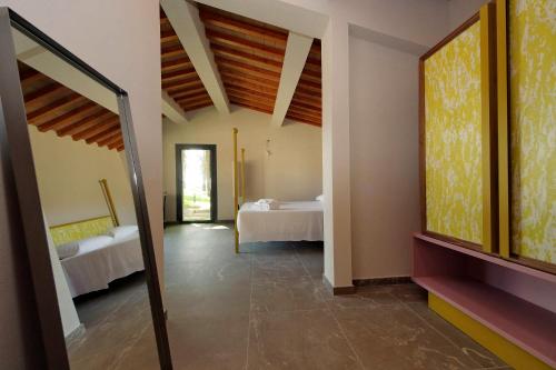 a room with two beds and a room with a mirror at The Monteleone Umbria Retreat in Monteleone dʼOrvieto
