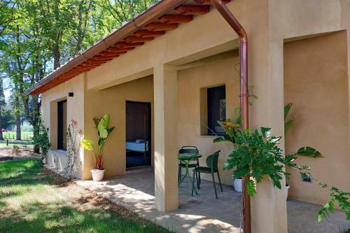 a patio of a house with a table and chairs at The Monteleone Umbria Retreat in Monteleone dʼOrvieto