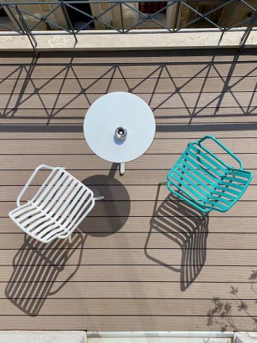 a white bench and a basket on a wall at Evripides Hotel in Athens