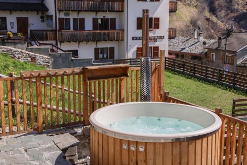 a hot tub on a deck with a fence at Modern chalet with hot tube in Campo