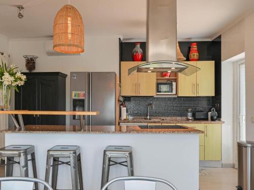 a kitchen with a counter with bar stools at Elegant Villa with Pool in Benissa