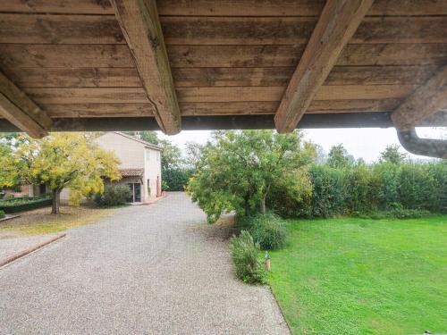 a view from under a porch of a house at Quaint Mansion in Stagno Lombardo with Garden in Stagno Lombardo