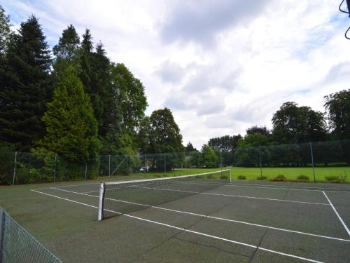 a tennis court with a net on it at Delightful Castle in Bastogne with bubble bath in Bastogne