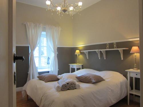 a bedroom with a bed with towels on it at Delightful Castle in Bastogne with bubble bath in Bastogne