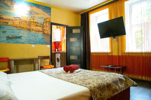 a bedroom with a bed with a stuffed animal on it at Doba in ua Starokazatskay Apartments in Dnipro