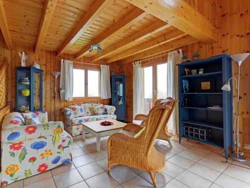 a living room with a couch and a table at A luxurious 6 person chalet with superb view in Les Collons